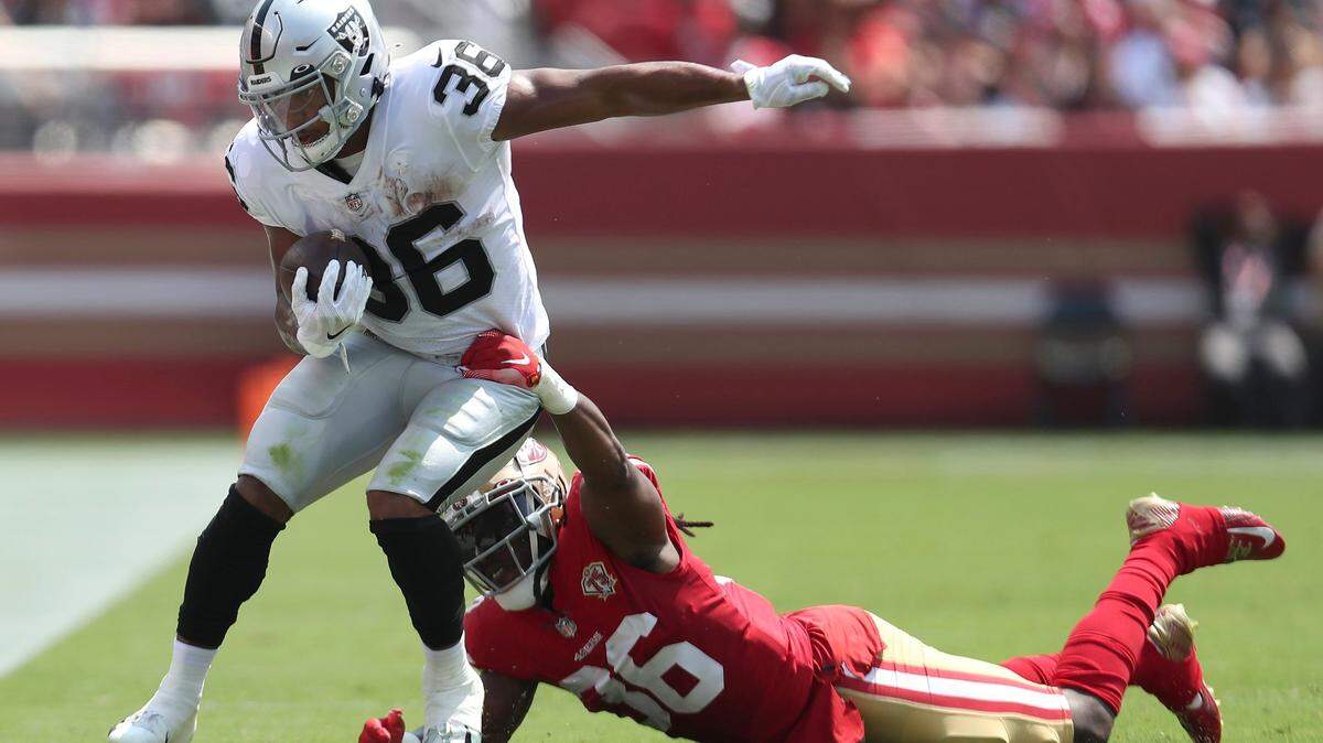 Las Vegas Raiders running back Trey Ragas, left, runs against San Francisco 49ers defensive back Marcell Harris during the first half of an NFL preseason football game in Santa Clara, Calif., Sunday, Aug. 29, 2021.