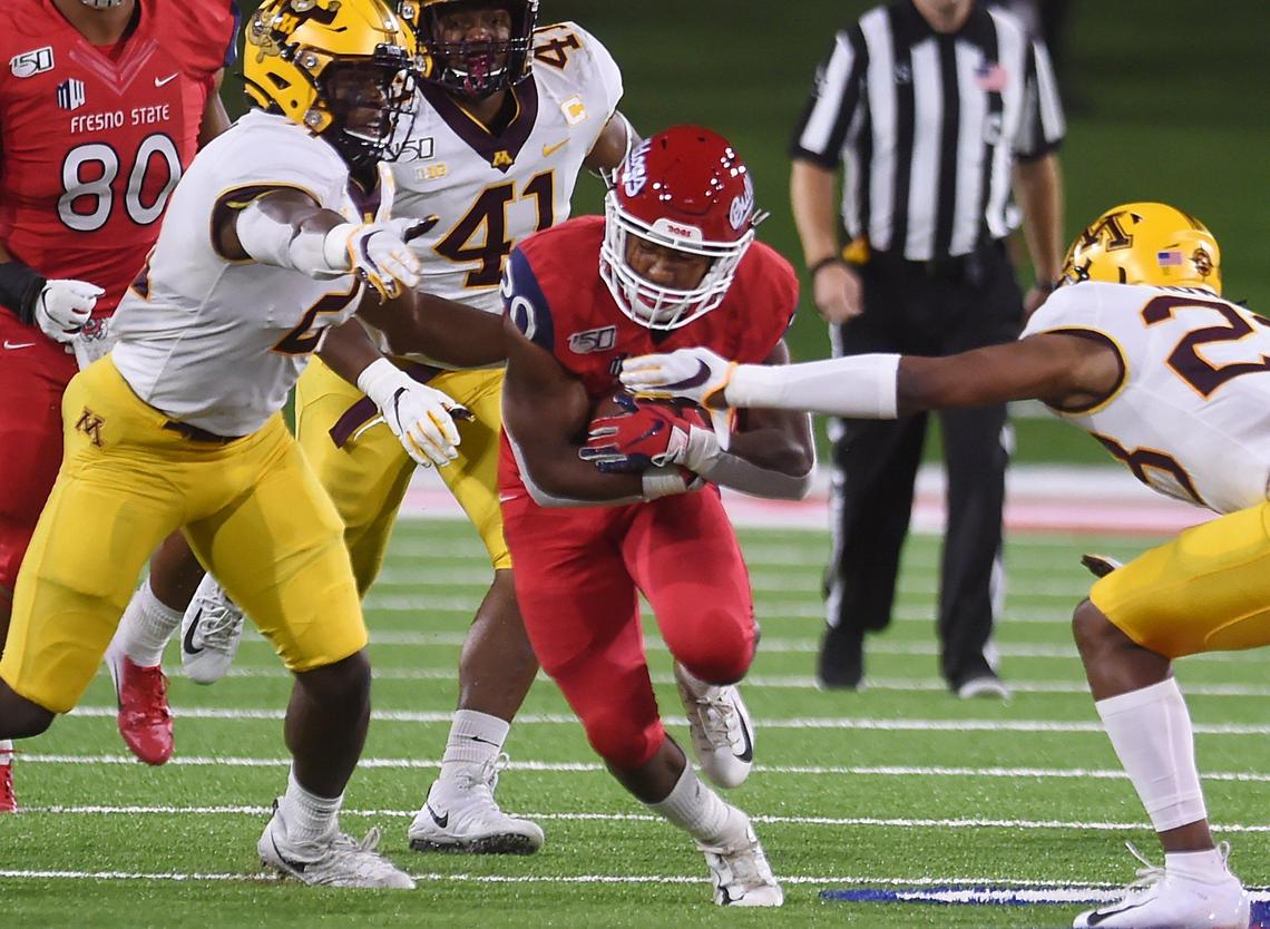 Fresno State’s Ronnie Rivers, center, tries to run up the middle against Minnesota Saturday, Sept. 7, 2019 in Fresno. Minnesota led 14-10 at halftime