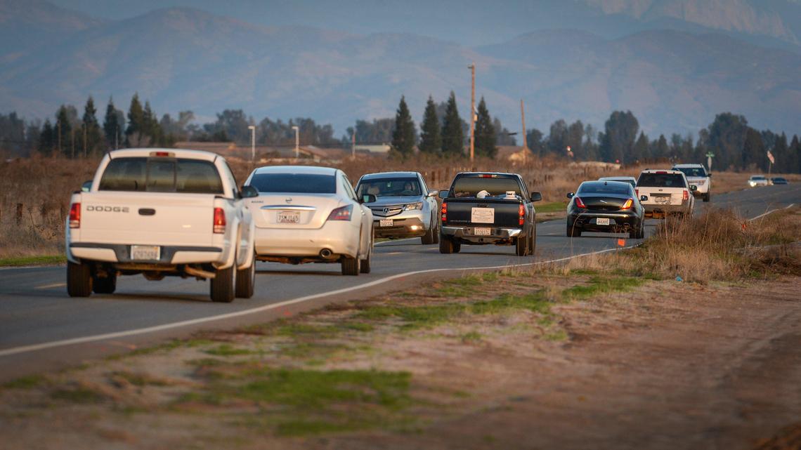 Traffic on Avenue 9 in southern Madera County picks up as the evening commute gets underway on Monday, Dec. 17, 2019. The rural two-lane road is heavily used by Fresno and Clovis residents as a quicker cutoff between Highways 41 and 99.