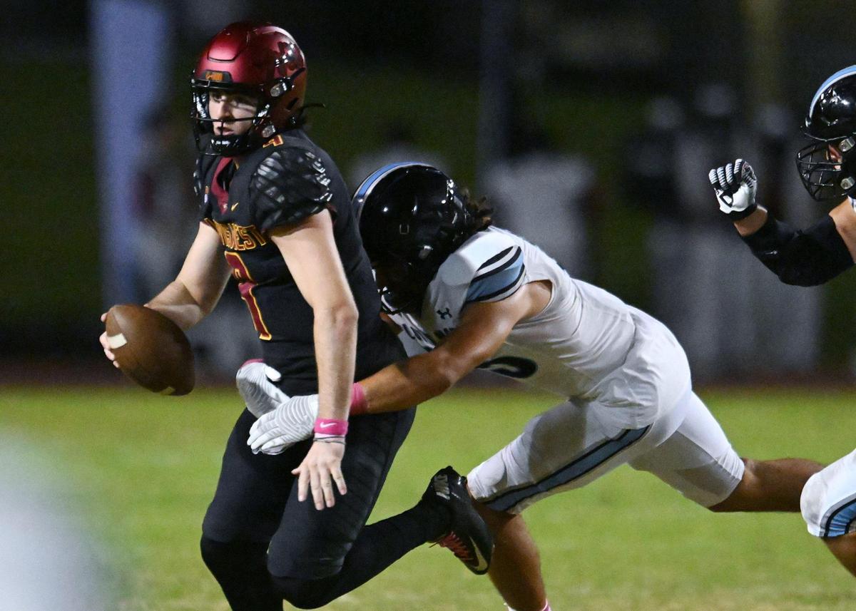 Clovis North’s Darius Storey sacks Clovis West quarterback Tyler Patrick in first-quarter action Friday, Oct. 13, 2023, in Clovis.