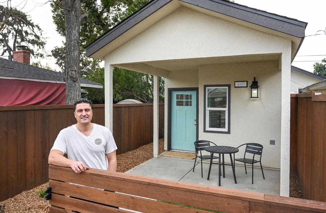 Property owner Brandon Telesmanic stands in front of the accessory dwelling unit or ADU he had built next to a house he owns in a Fresno neighborhood. Telesmanic plans to use the ADU as a rental property which is a growing trend in Fresno.