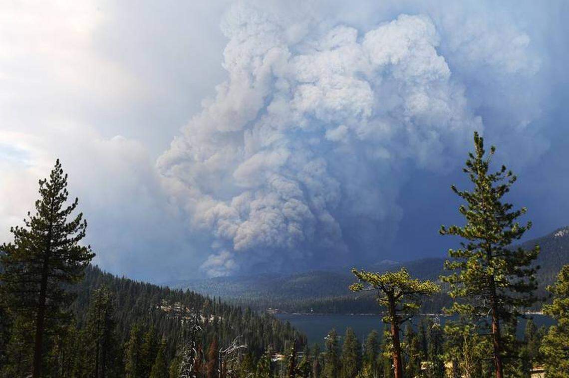 Smoke from the Creek Fire billows into the sky beyond Huntington Lake in the foreground on Saturday, Sept. 5, 2020.