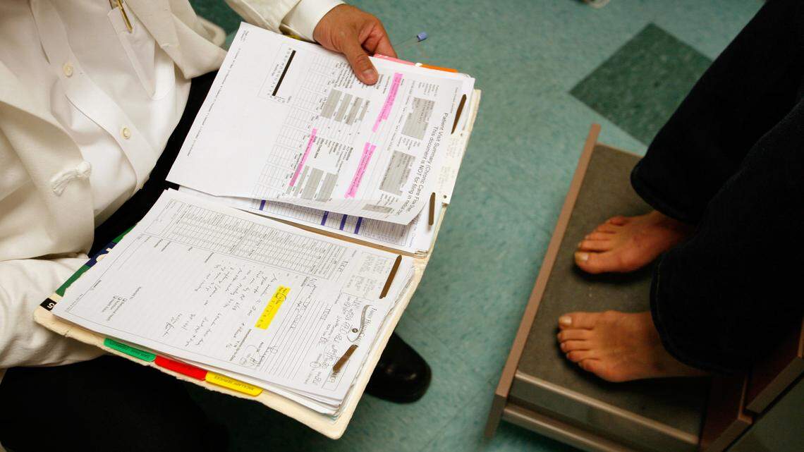 A doctor checks on a patient at the Family Healthcare Network clinic in Visalia in 2009. The company was sued for discrimination against pregnant and disabled employees by the U.S. Equal Employment Oppor­tunity Commission.