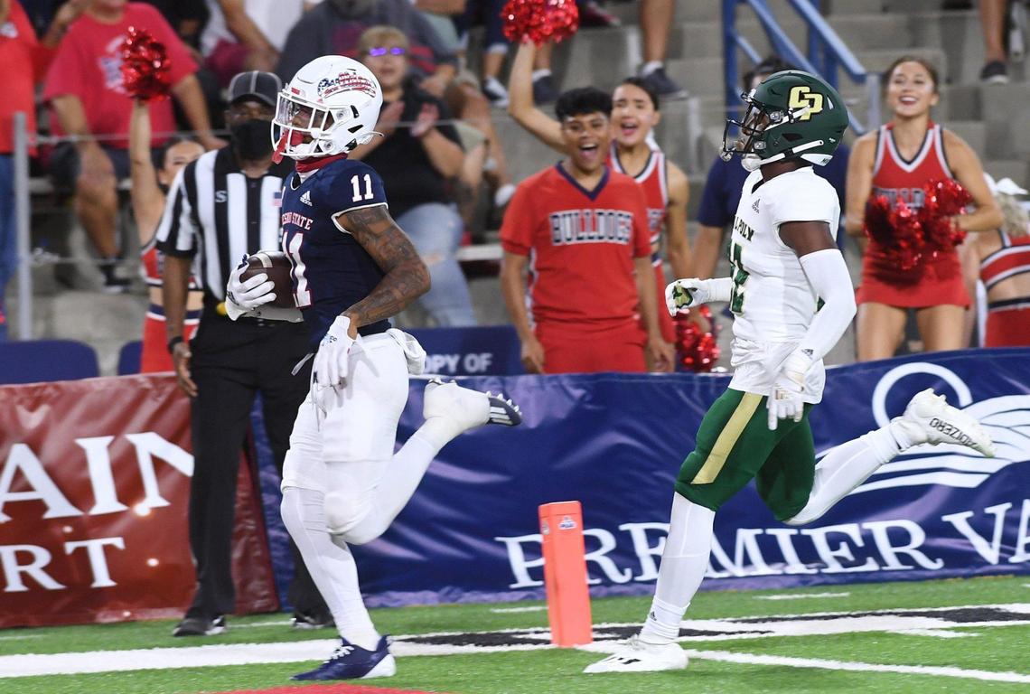 Fresno State wideout Josh Kelly scores a touchdown while chased by Cal Poly’s Christian Middleton in the Bulldogs’ 63-10 victory over the Mustangs Saturday, Sept. 11, 2021 in Fresno.