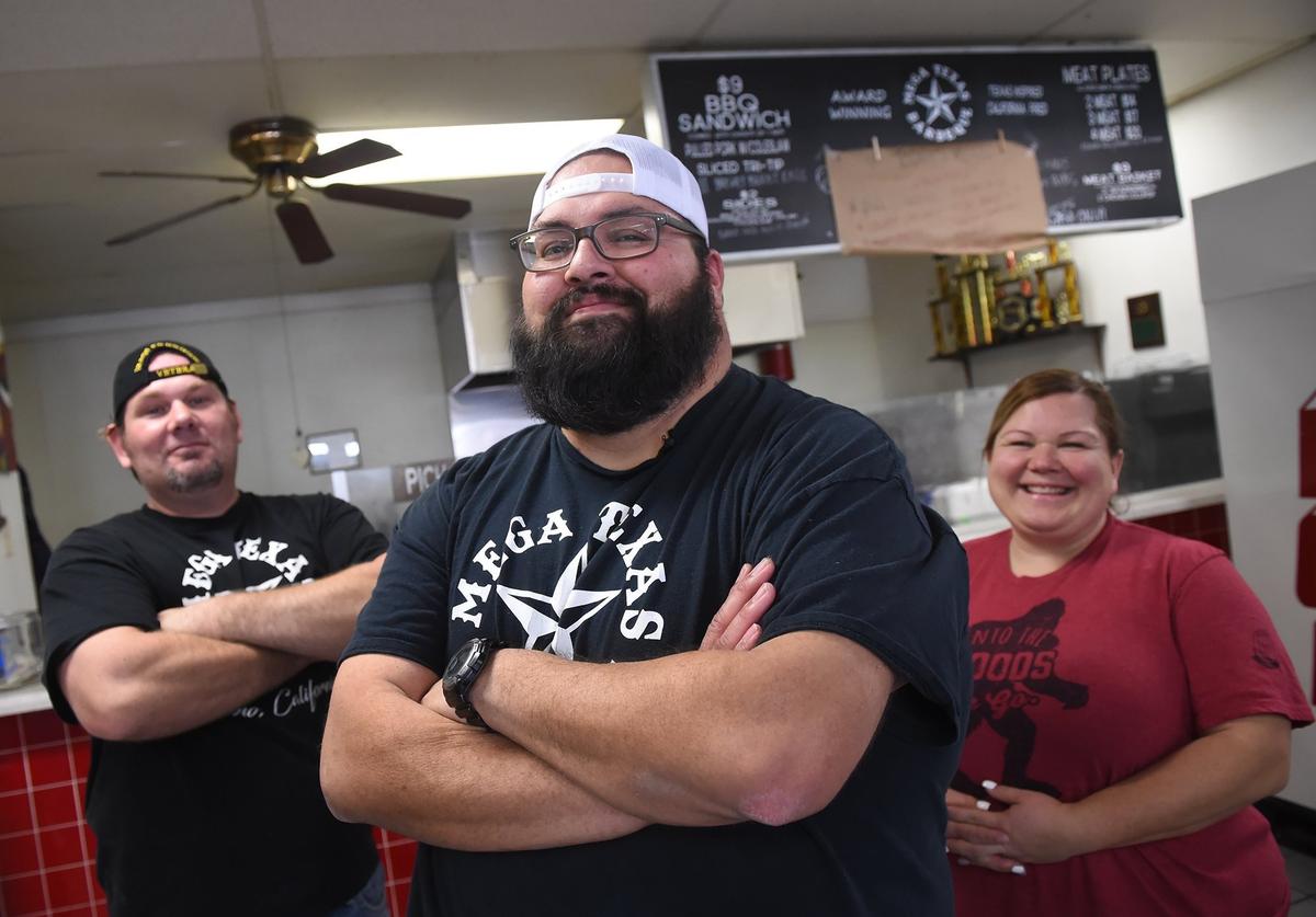 Curtis Hellman, left, and Tasha Vallejo, right, work with Anthony Vallejo, center, at Mega Texas Barbeque, located in an Arco gas station at Fresno St. and McKinley Ave. in Fresno. Photographed Thursday, Jan. 24, 2019 in Fresno.
