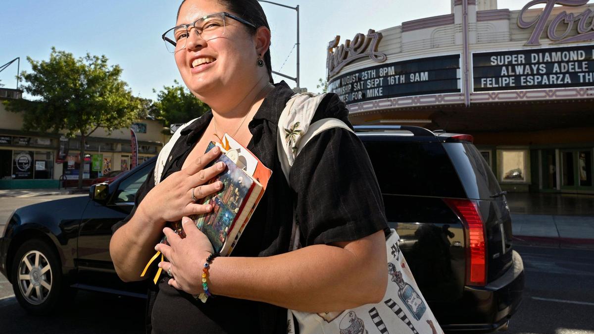 Brooke Payton clutches a notebook and bag filled with information and contacts she’s gathered over time as she spearheads a movement to re-establish a library in the Tower District. Fresno County Library’s Gillis branch was once located along Olive Avenue in the Tower District before moving to its current location on Dakota Avenue near Fruit Avenue around 50 years ago. Photographed Friday, Aug. 18, 2023 in Fresno.