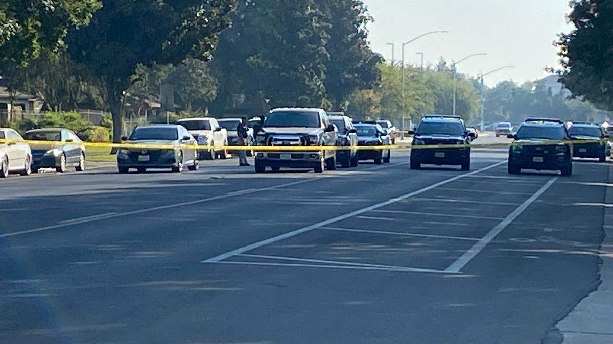 Police block off Lane Avenue on Thursday, Oct. 19, 2023, after a 15-year-old was shot several times in Fresno.
