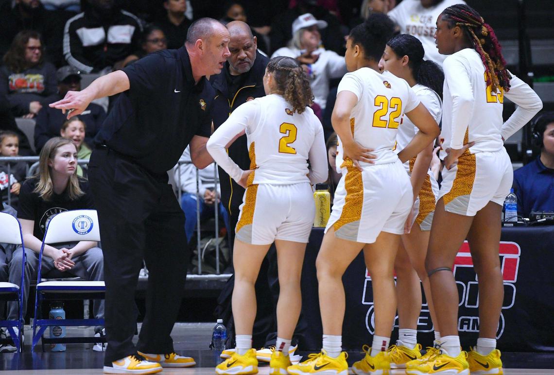 Clovis West head coach Craig Campbell, left, lectures the team during a time-out against Clovis High in the Central Section girls Division I basketball championship Saturday, Feb. 25, 2023 in Fresno.