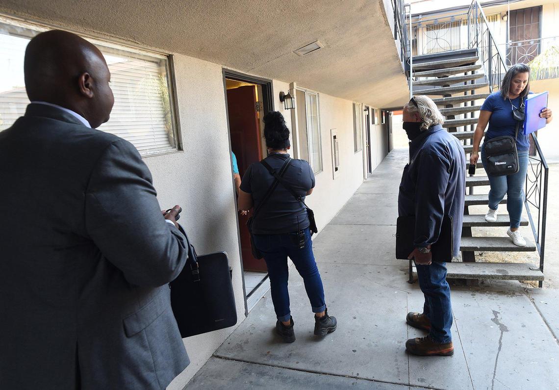 Fresno Code Enforcement manager Rodney Hicks, left, watches department inspectors make the rounds at Manchester Arms apartments, Thursday June 17, 2021, to reinspect units, and to confirm that violations within the units have been corrected. Hicks said, “habitability is an issue that we want to achieve here at Manchester Arms and of course remove the substandard housing violations.”