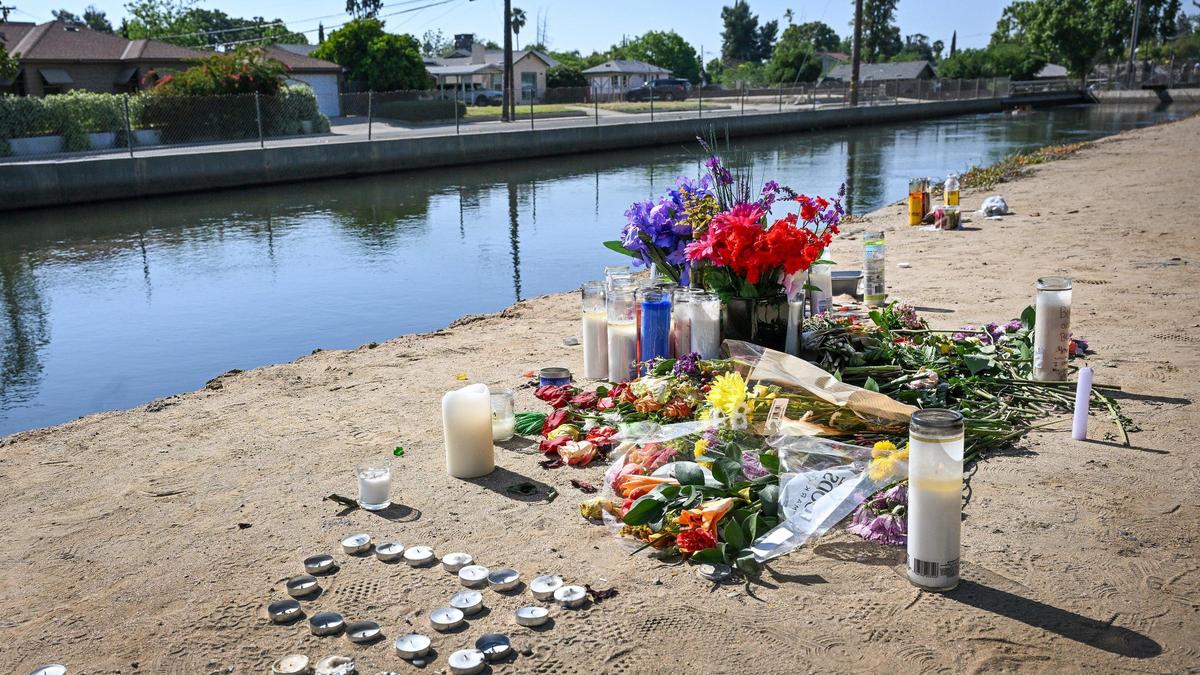 A memorial left following a vigil for a motorcycle rider killed Friday, May 2, appears on the bank of the canal at Maroa Avenue at Fedora in Fresno on Monday, May 5, 2025. The victim of the collision was 21-year-old Bryce Tomlinson of Fresno.