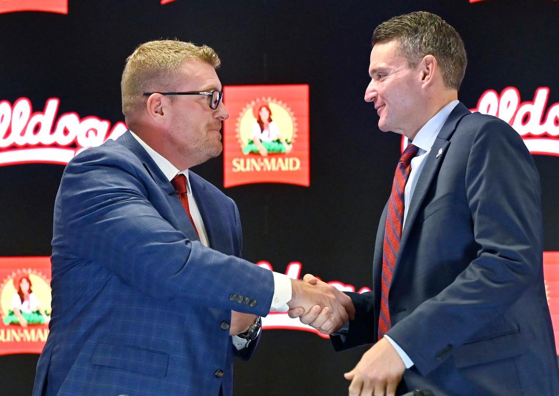 New head football coach Matt Entz, left, shakes Fresno State athletic director Garrett Klassy’s hand, right, after a press conference Thursday, Dec. 5, 2024 in Fresno.