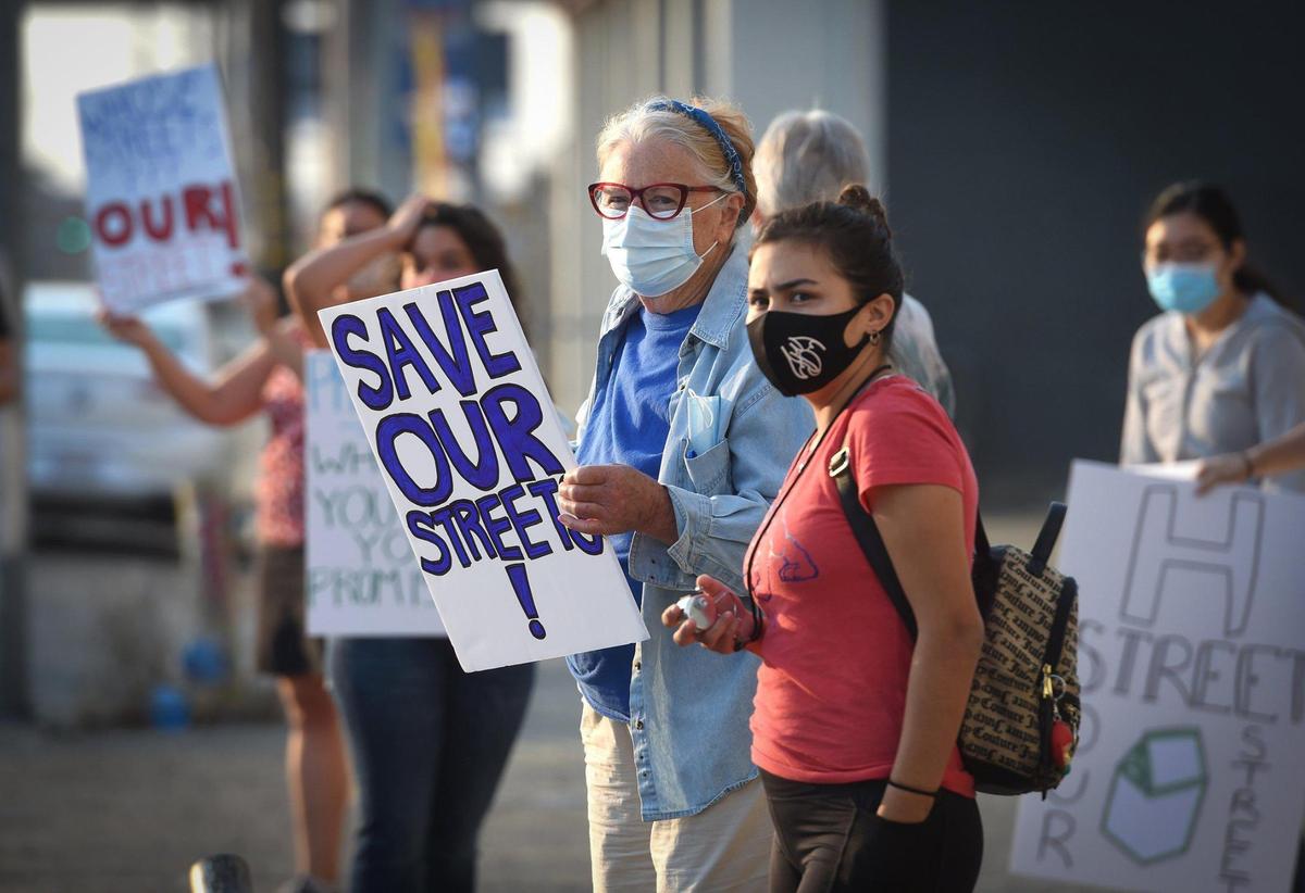 Malyn Rose, an H Street area resident for over 40 years, center, joined protestors early Thursday morning Sept. 3, 2020, to voice opposition to a proposal by Producers Dairy Foods to close off the busy street for the industry’s truck parking.