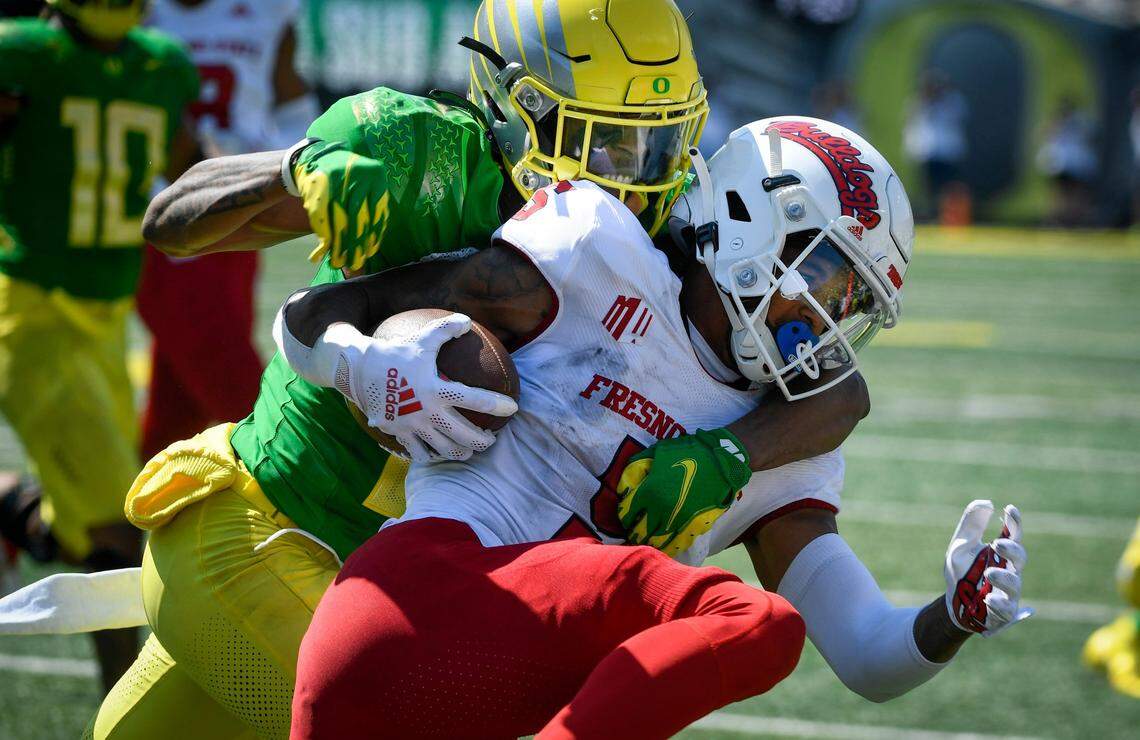 Fresno State wide receiver Jalen Cropper is tackled by Oregon cornerback Mykael Wright during the fourth quarter of the Ducks’ 31-24 victory Saturday, Sept. 4, 2021.