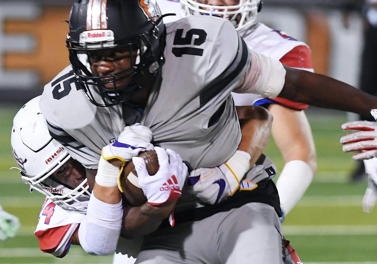 Buchanan’s Cheney Bishop, left, tackles Central’s Imari Conley, right, Friday, Oct. 7, 2022 in Fresno. Buchanan won 49-41.
