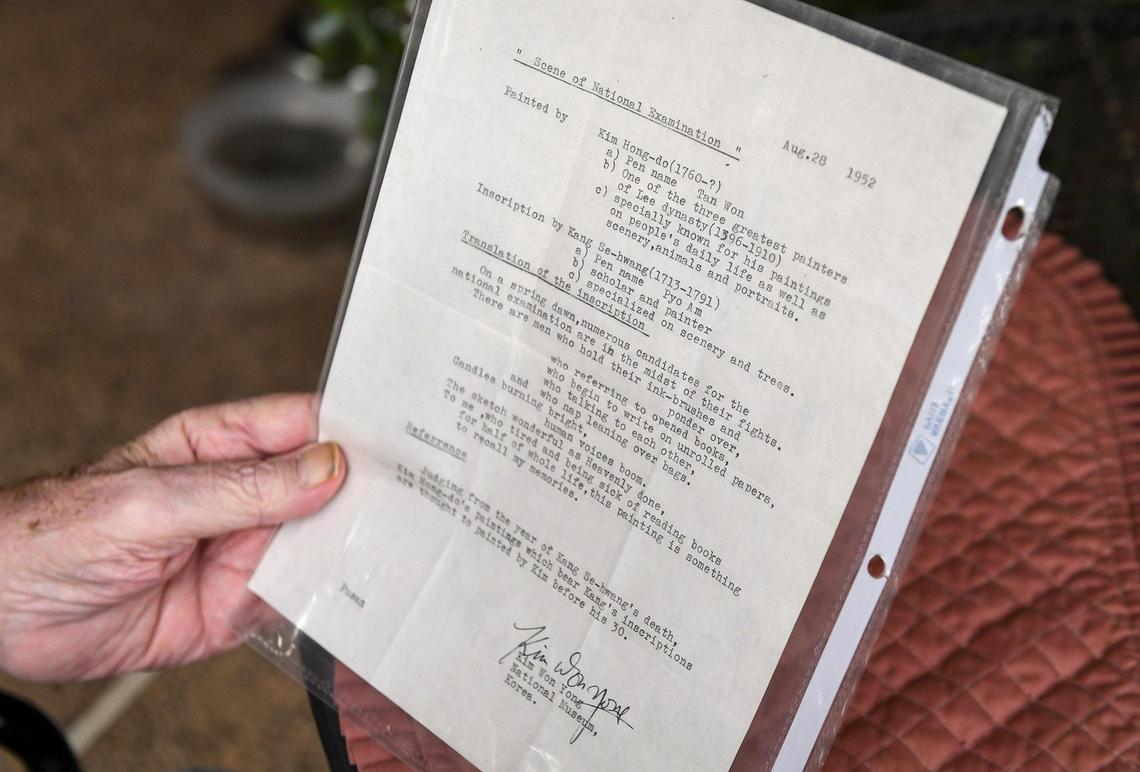 Pat Patterson holds a copy of a letter from 1952 explaining the meaning of the painting that Patterson purchased at an Fresno estate sale.