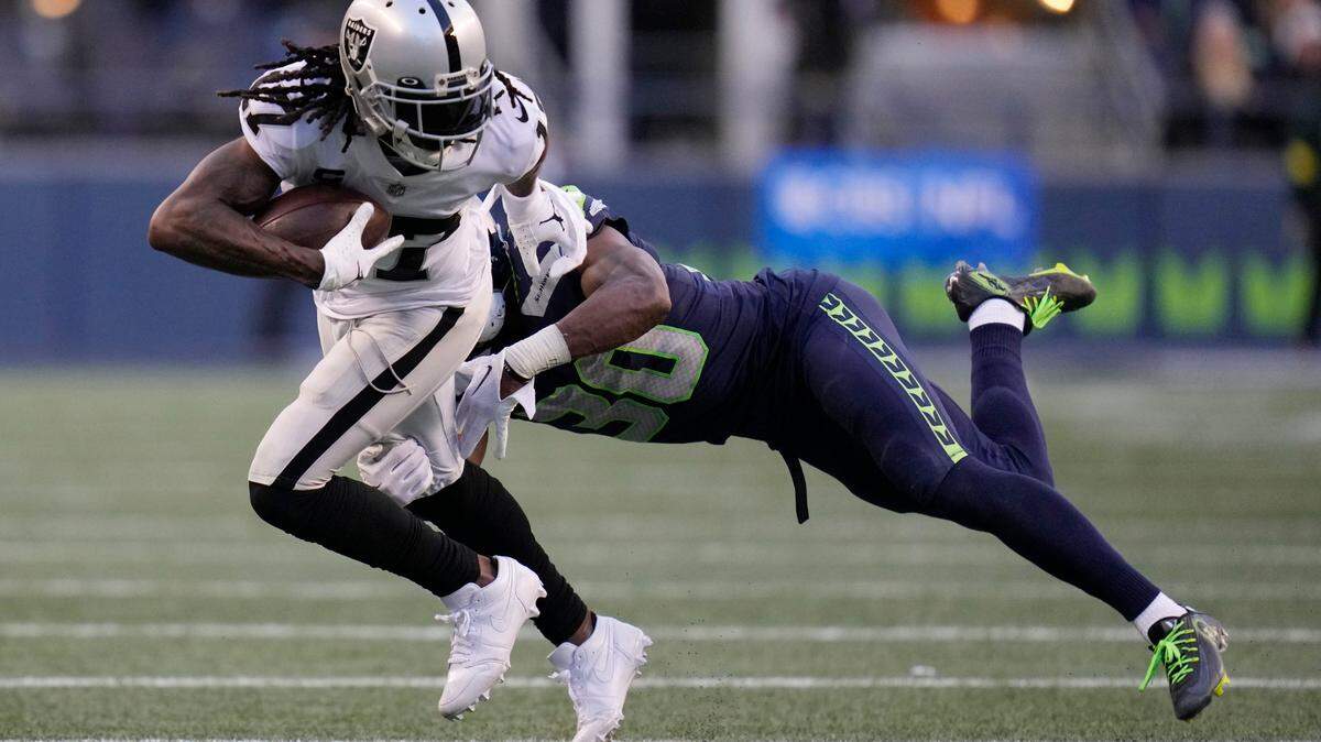 Las Vegas Raiders wide receiver Davante Adams runs after a catch against the Seattle Seahawks during the second half of an NFL game Sunday, Nov. 27, 2022, in Seattle.