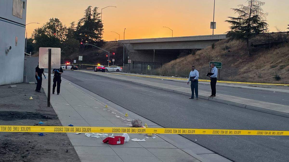 Investigators at the scene of a homicide in the area of Fulton Street and Belmont Avenue, just north of Highway 180 in Fresno, early Saturday morning, Sept. 24, 2022.