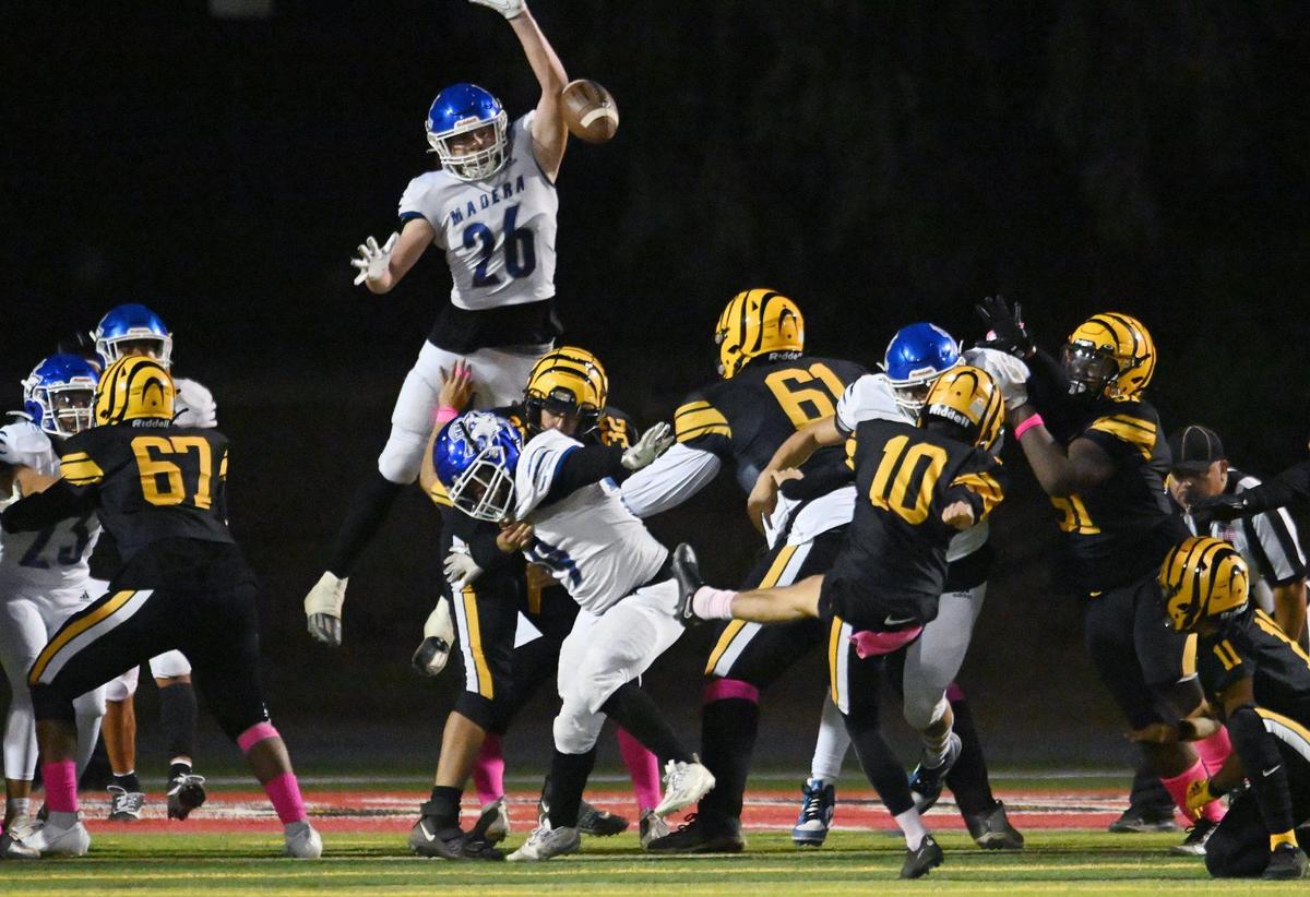 Madera’s Josue Madrigales, top, tries to block Edison kicker Robert Perez’s extra point Friday, Oct. 20, 2023 in Fresno.