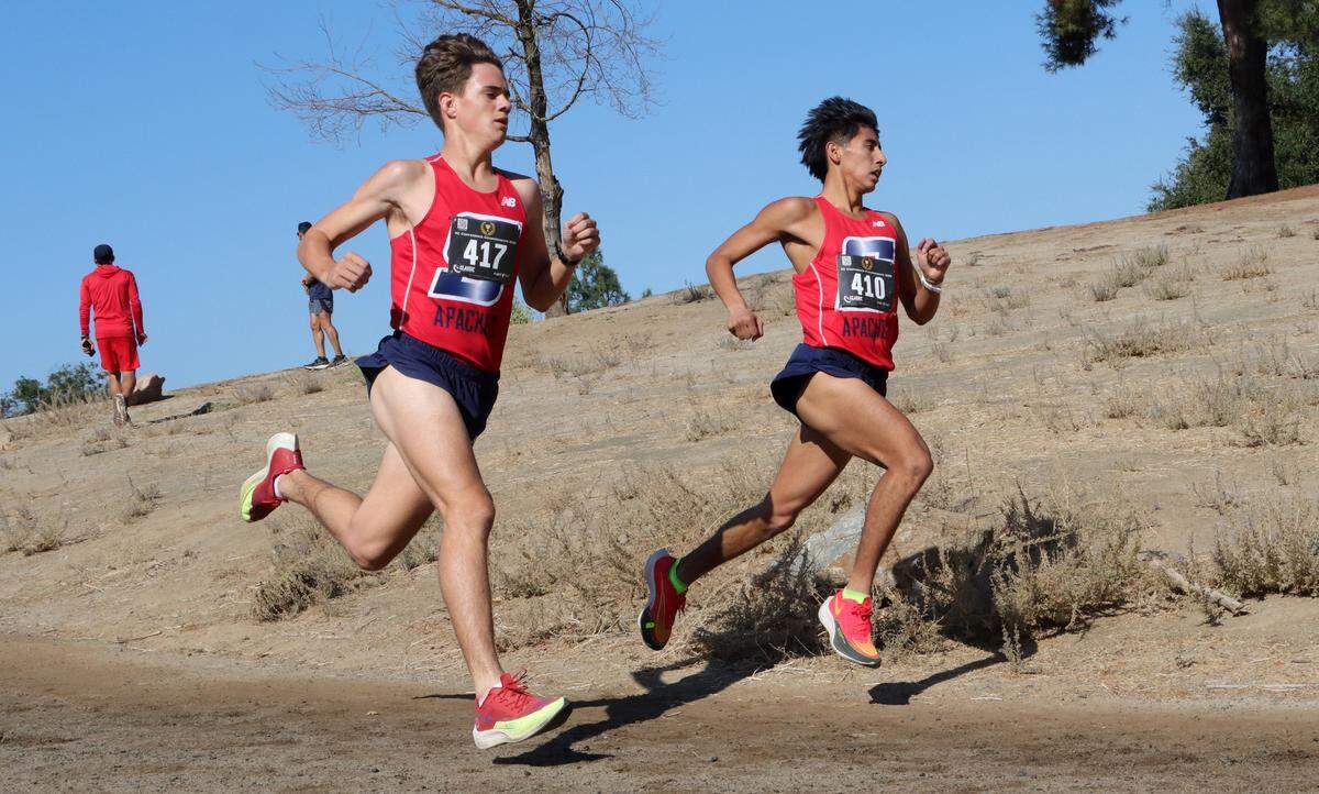 Sanger High senior Daniel Galvez holds a slight lead against junior teammate Sawyer Pugliese during the CMAC cross country championships at Woodward Park on Nov. 8, 2023. Galvez won in 15:54.1, and Pugliese was second in 16:10.6.