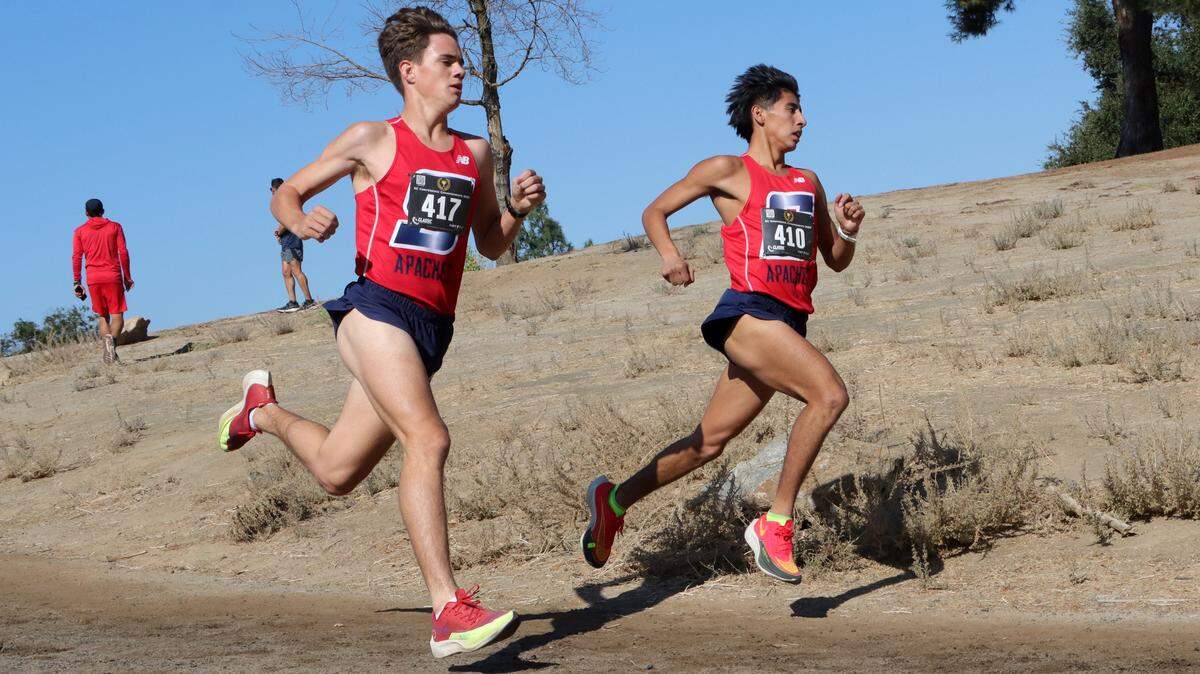 Sanger High senior Daniel Galvez holds a slight lead against junior teammate Sawyer Pugliese during the CMAC cross country championships at Woodward Park on Nov. 8, 2023. Galvez won in 15:54.1, and Pugliese was second in 16:10.6.