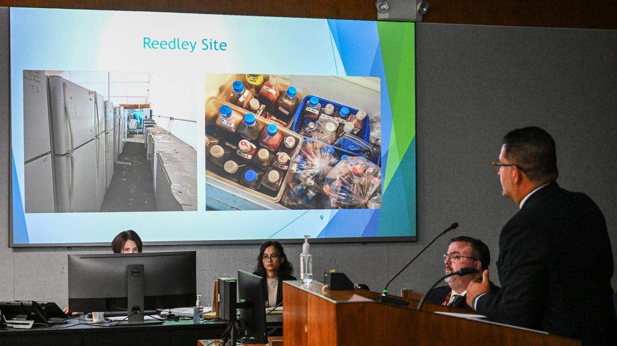 Fresno County Assistant Director of Public Health Joe Prado, right, projects images of refrigerators, freezers and various liquids found in a Reedley warehouse run by a Chinese-owned company under investigation for operating illegally, during a timeline presentation at the Fresno County Board of Supervisor’s meeting on Tuesday, Aug. 8, 2023. AB 1864 would make California the first state to require screening of custom mail-order DNA and gene synthesis orders to prevent misuse and protect the public.