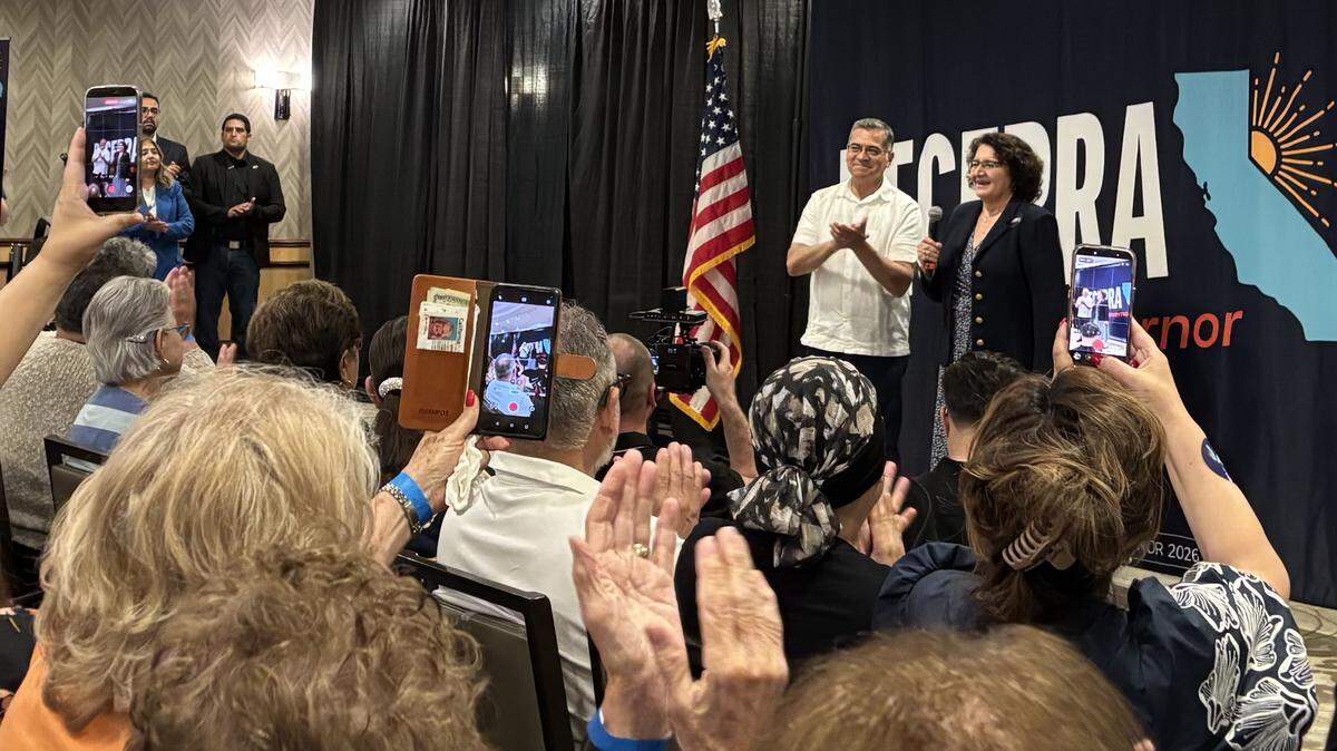 Former California Attorney General Xavier Becerra and his wife, Dr. Carolina Reyes, speak to a crowd at a gubernatorial campaign rally at the Doubletree Hilton in downtown Fresno on Saturday May 23, 2026.