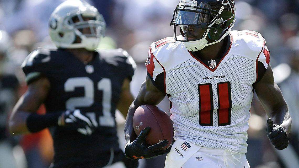 Atlanta Falcons wide receiver Julio Jones runs past former Raiders cornerback Sean Smith to score on a touchdown during a game Sept. 18, 2016, in Oakland.