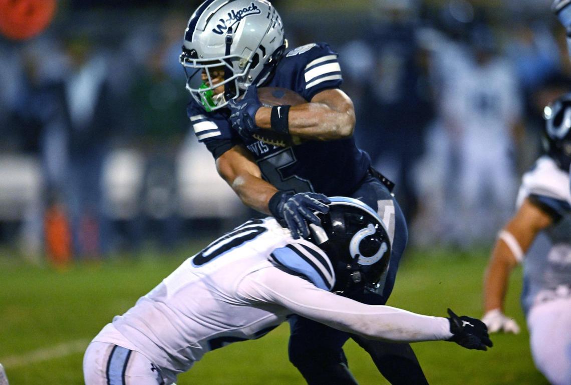 Clovis East’s Taemell Horton, background, evades Clovis North’s Wyatt Johnson Friday, Nov. 1, 2024. Clovis East won 38-21.