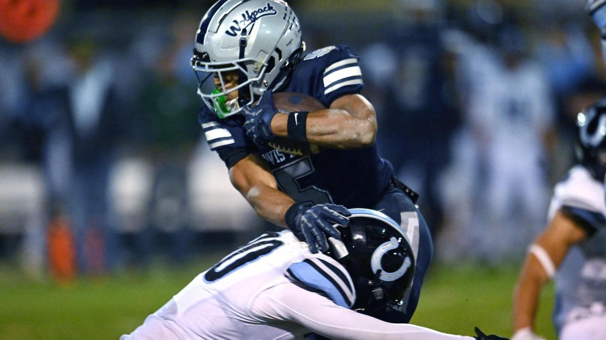 Clovis East’s Taemell Horton, background, evades Clovis North’s Wyatt Johnson Friday, Nov. 1, 2024. Clovis East won 38-21.