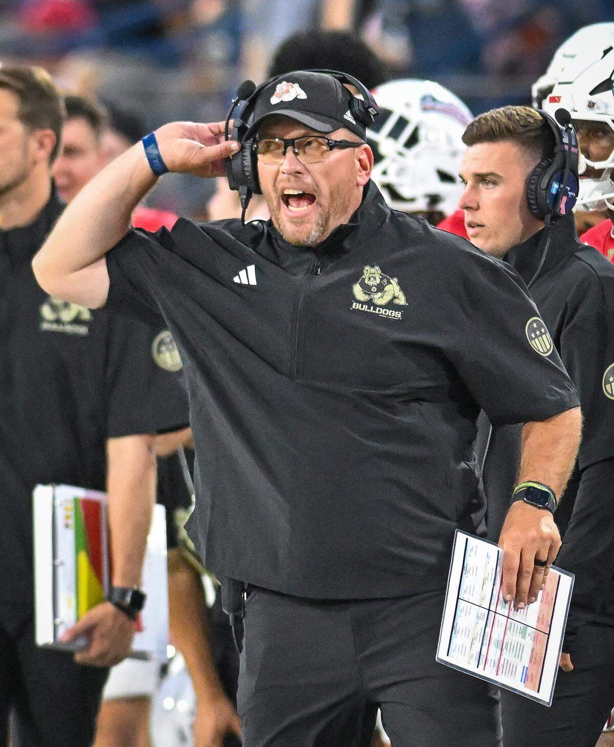Fresno State head football coach Matt Entz makes calls from the sidelines during the Bulldogs game with Southern University at Valley Children's Stadium on Friday, Sept. 13, 2025. 