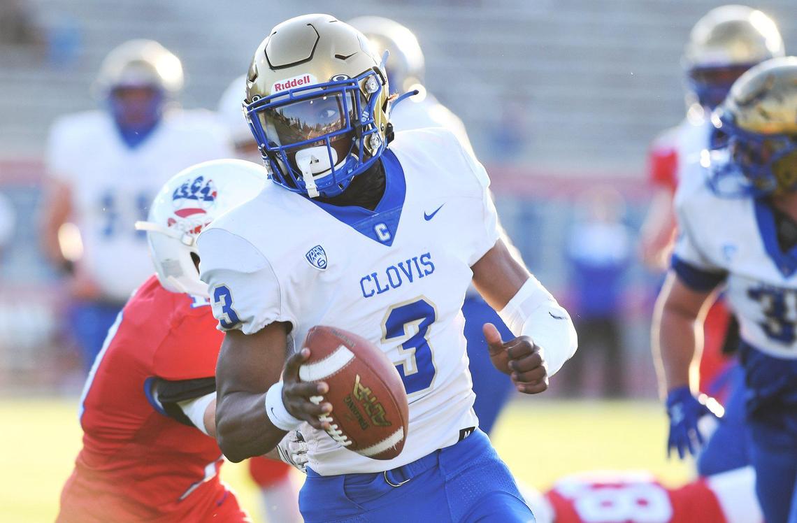 Clovis High’s Nate Johnson swings wide of Buchanan’s Harrison Kalpakoff, background, Thursday, April 1, 2021 in Clovis.
