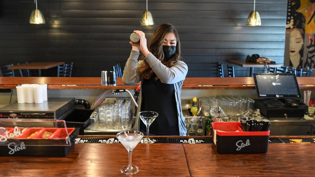 Anna Nguyen mixes a lychee-mini at the bar at Banzai, a new Japanese cuisine restaurant in the Tower District on Friday, March 26, 2021.