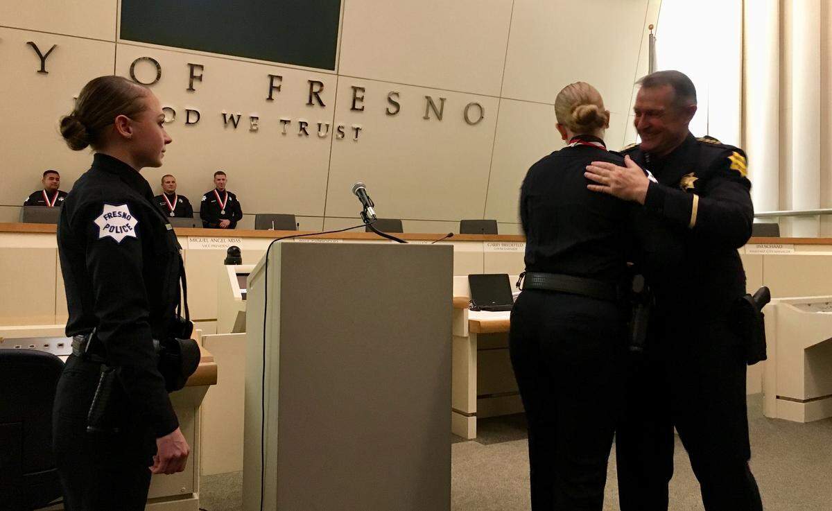 Fresno Police Chief Andrew Hall presents his department’s Lifesaving with Valor Medal to Officer Rebekah Wells, right, before presenting the same medal to Officer Alana Williams, left, on Dec. 19, 2019 at Fresno City Hall.