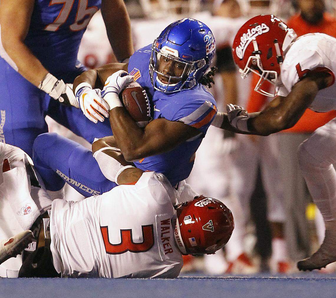 Boise State running back Alexander Mattison (22) is brought down by Mykal Walker (3) with Tank Kelly closing in during the first half of Friday’s game.