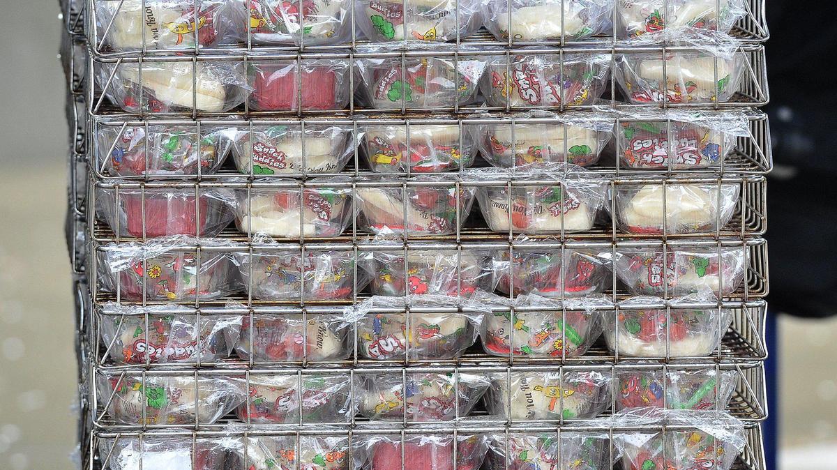 Lunches in a rack wait to be handed out to students at a school drive-thru. It was part of Fresno Unified’s effort to ensure children were fed last year when the COVID pandemic began.