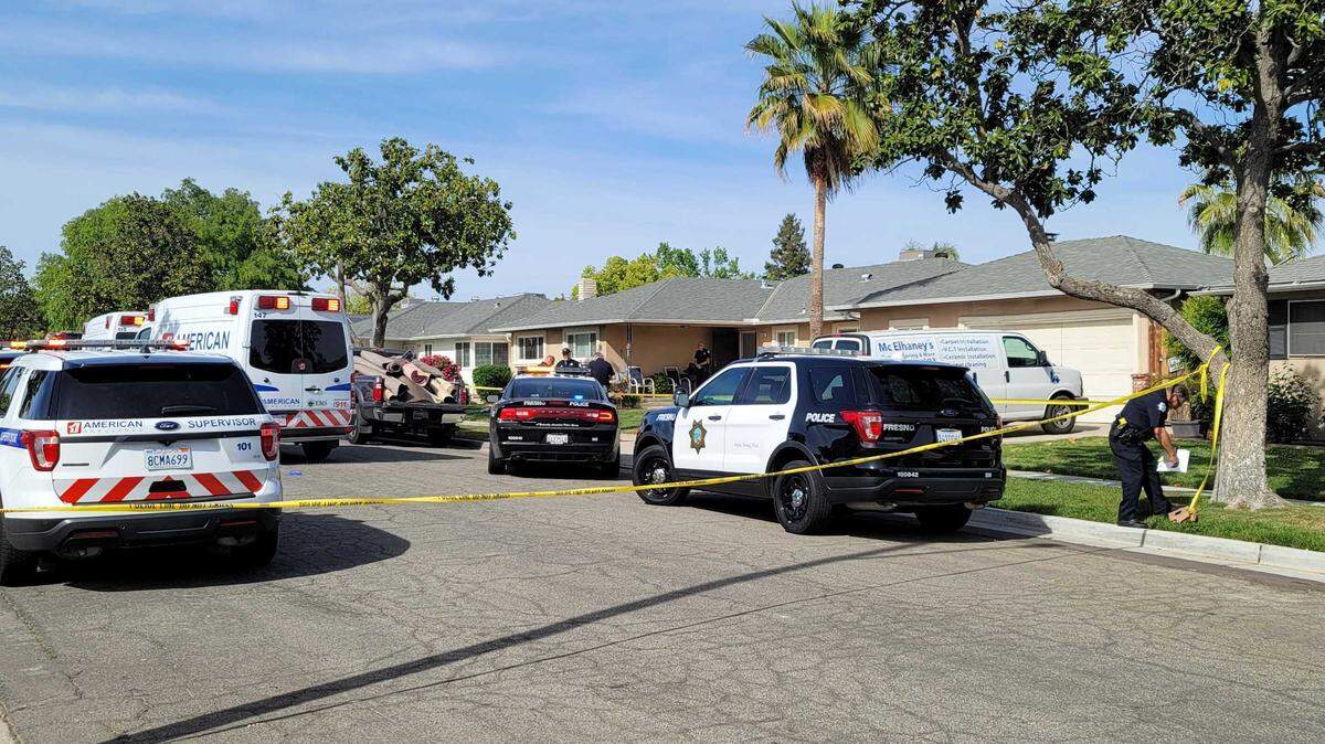 Police investigate at the scene of a double shooting at Bullard Avenue and 10th Street in Fresno, where investigators say a couple was killed.