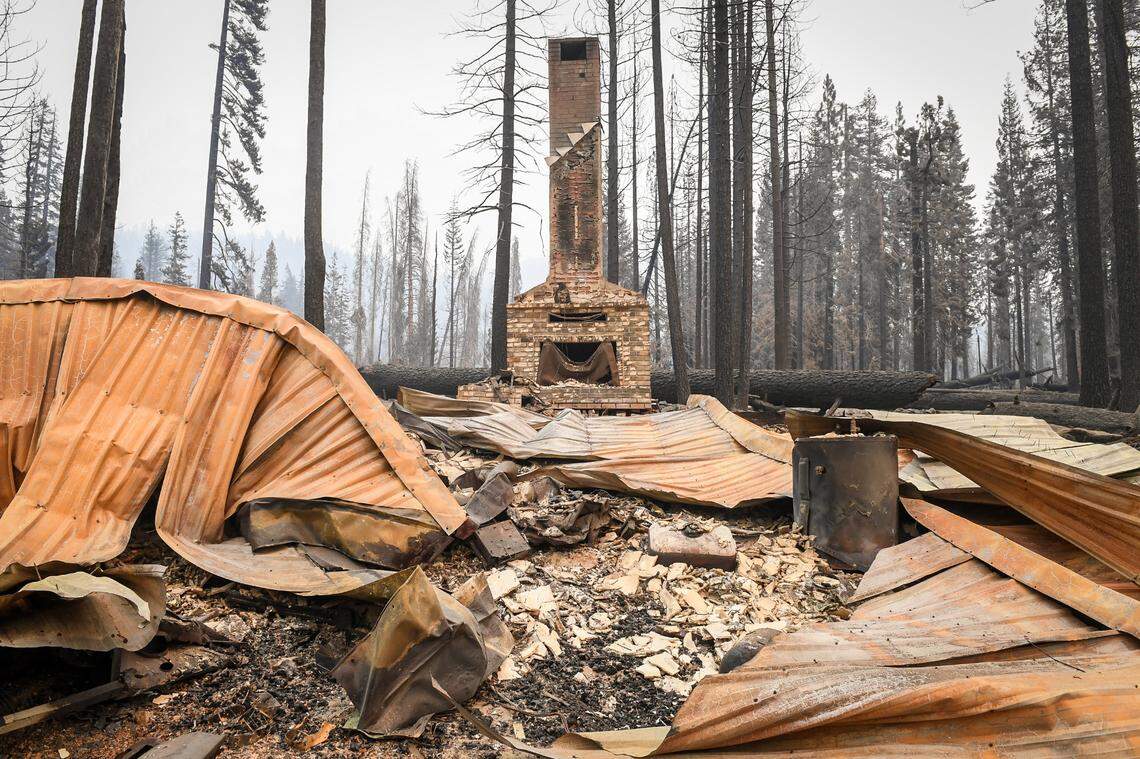 A chimney is the only identifiable structure standing in a burned cabin in the Camp Silver Fir area on the north of Huntington Lake on Sunday, Sept. 13, 2020. Fire officials said a fire tornado blew through the area at some point last week burning cabins and knocking down many trees.