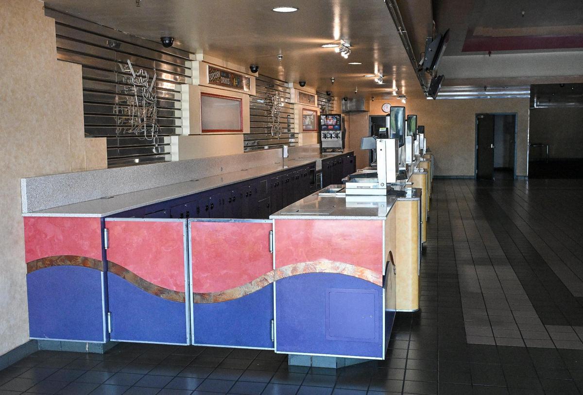 Looking through the windows at the UA Clovis Movies 8 shows an empty lobby and concessions counter at its location on Villa Avenue near Shaw Avenue in Clovis on Monday, July 7, 2025.