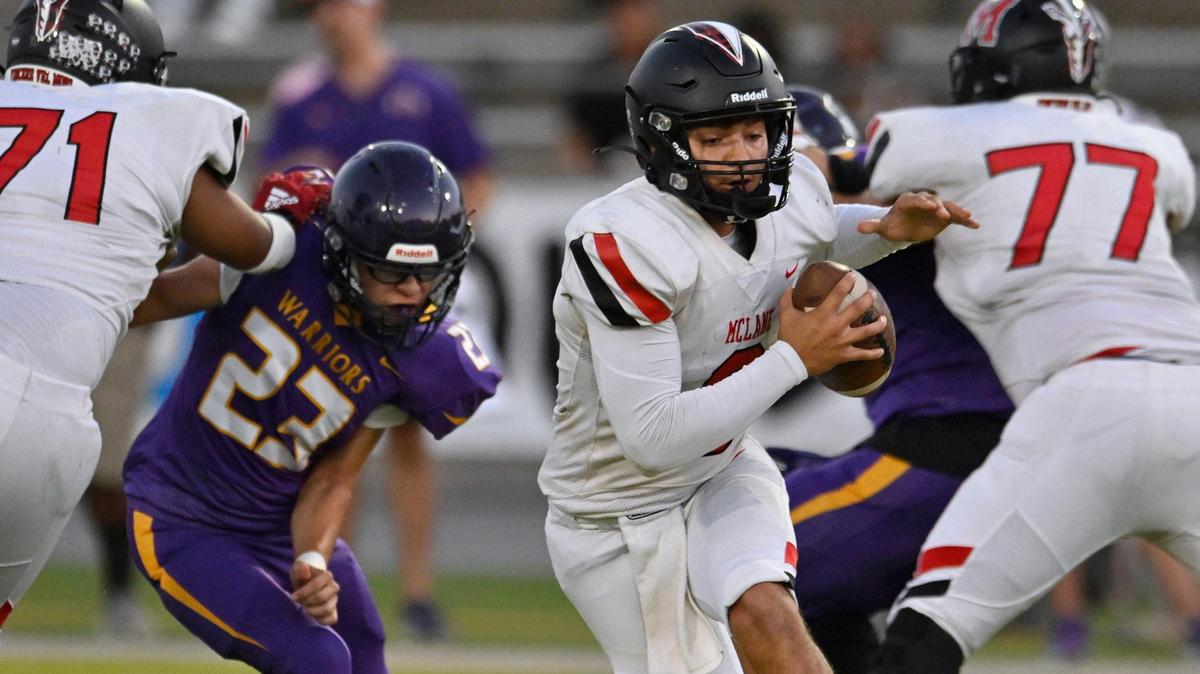 McLane quarterback Noah Zamora, center, scrambles through a hole in Fresno’s defense Thursday, Sept. 14, 2023 in Fresno.