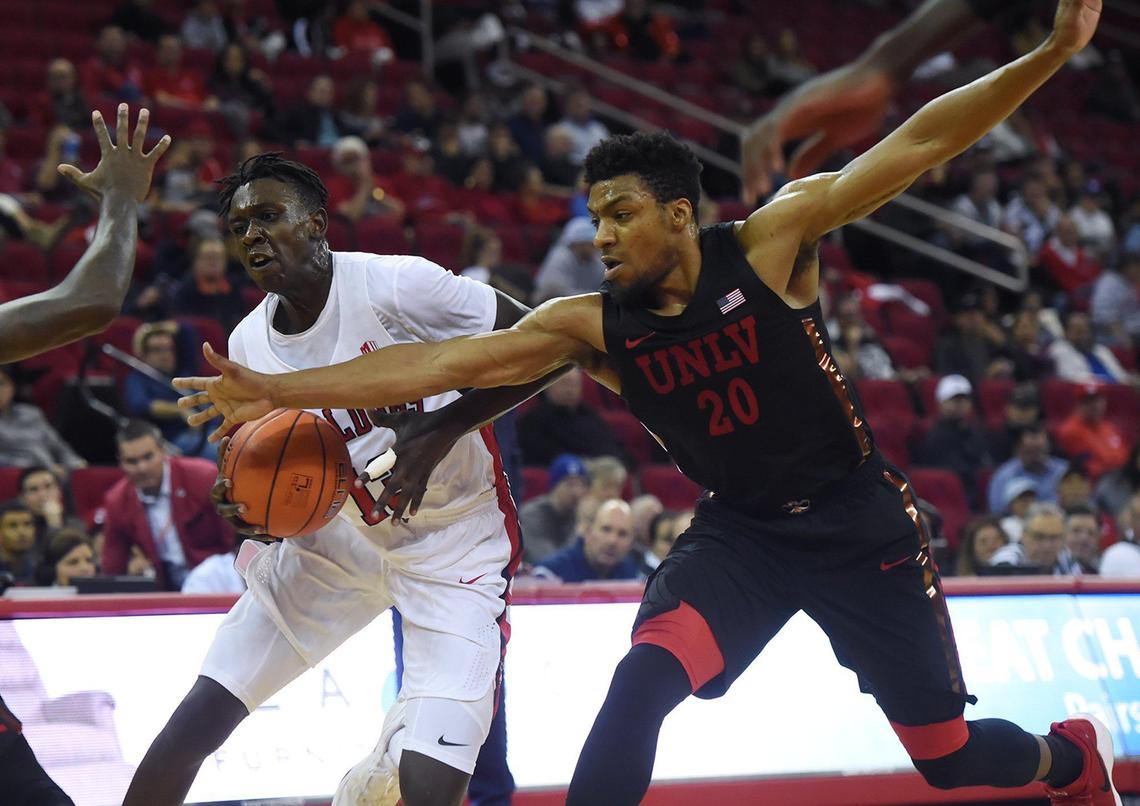 Fresno State guard Aguir Agau, center, and UNLV’s and Nick Blair, right, chase a loose ball in the Bulldogs’ Mountain West opener Wednesday, Dec. 4, 2019 in Fresno. UNLV won 81-80 in double overtime.
