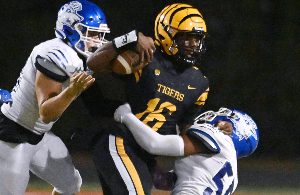 Edison quarterback Phoenix Lawrence is sacked against Madera Friday, Oct. 20, 2023 in Fresno.