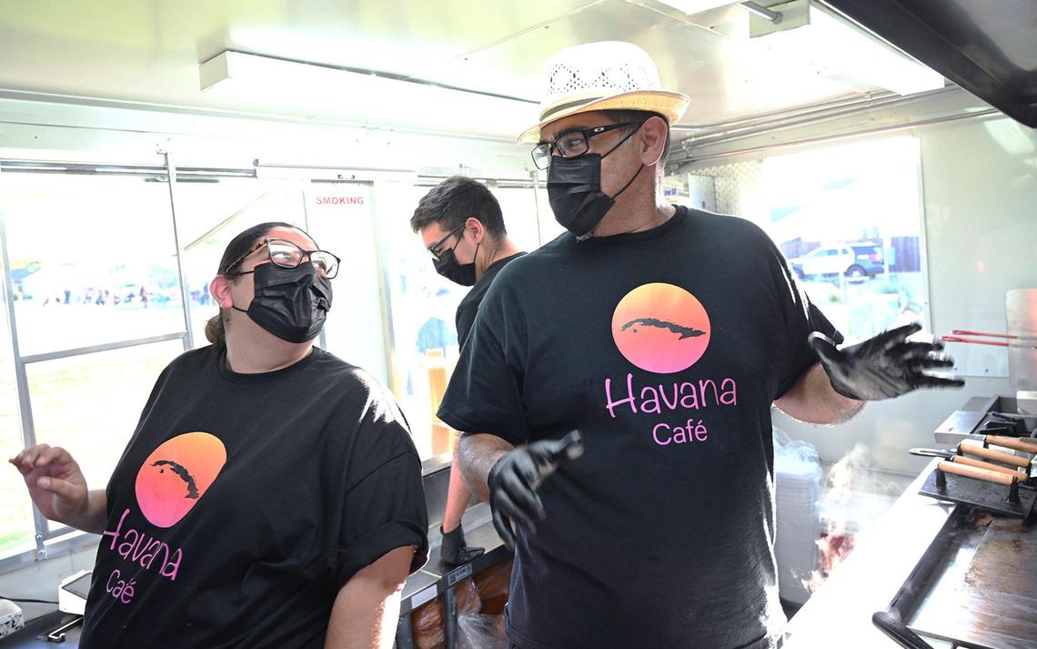 Jasmine Saldana, left, jokes with Lazaro Saldana, right, as family members prepare to begin serving Cuban food from Lazaro and his wife Niermin’s new food truck Havana Cafe at a community park gathering Wednesday, March 16, 2022 in Fresno. The Santana’s have opened a food truck staffed by family members which specializes in Cuban food and coffee.