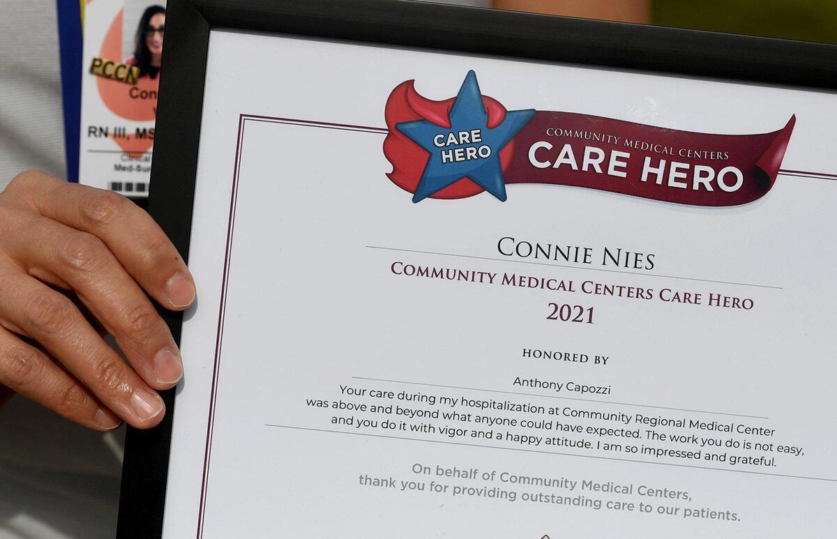 Community Regional Medical Center RN Connie Nies holds her Care Hero recognition award, Feb. 23, 2021, for care she helped provide for Fresno defense attorney Tony Capozzi, for a rare condition involving a 9-hour surgery, that he credits in saving his life.