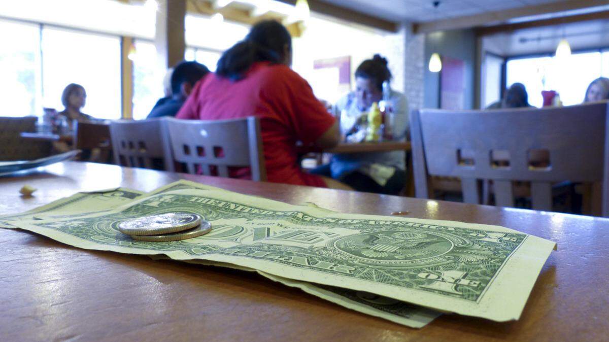Should waiters and bartender share a portion of their tips with kitchen workers?