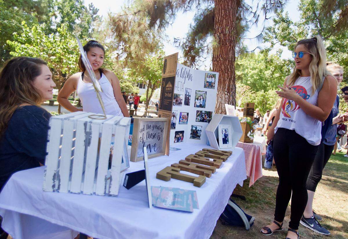Fresno State students gather around the Kappa Alpha Theta table at Greek Day at the university on Sept. 5, 2018.