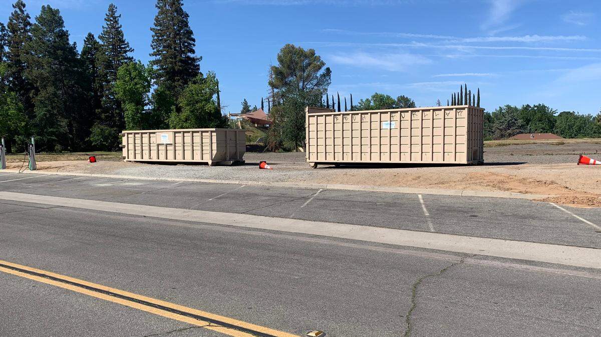 Roll-off bins block a service area at Woodward Park that was previously used as an informal parking area on Easter.