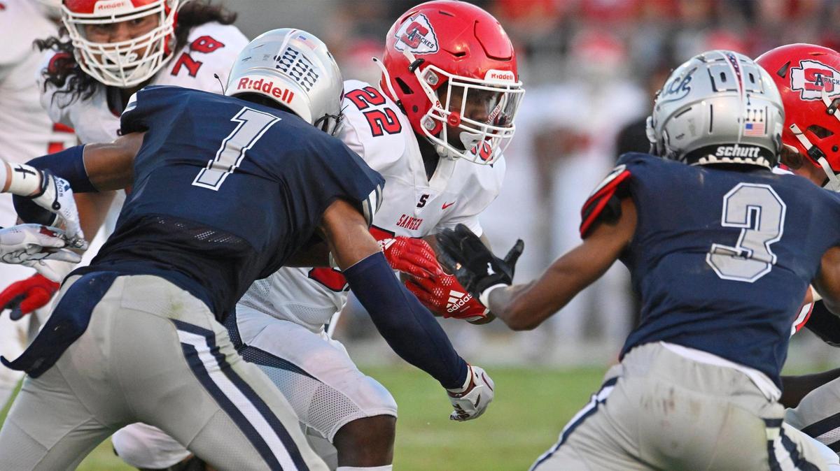 Sanger’s Israel Robles, center, runs against the Clovis East defense in the Silver Spear trophy game Thursday, Aug. 31, 2023 in Clovis. Clovis East won 42-21.