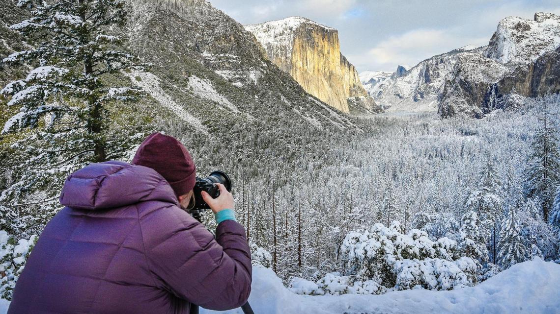 Arwin Levinson of Las Vegas makes pictures of Yosemite Valley at Tunnel View in Yosemite on Wednesday, Dec. 15, 2021, following a snowstorm the day before.