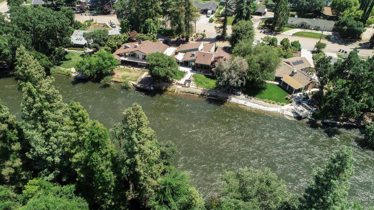 The Kings River flows at a high rate causing some bank erosion near a housing area north of Highway 180 and Piedra Road in eastern Fresno County on Wednesday, May 17, 2023.