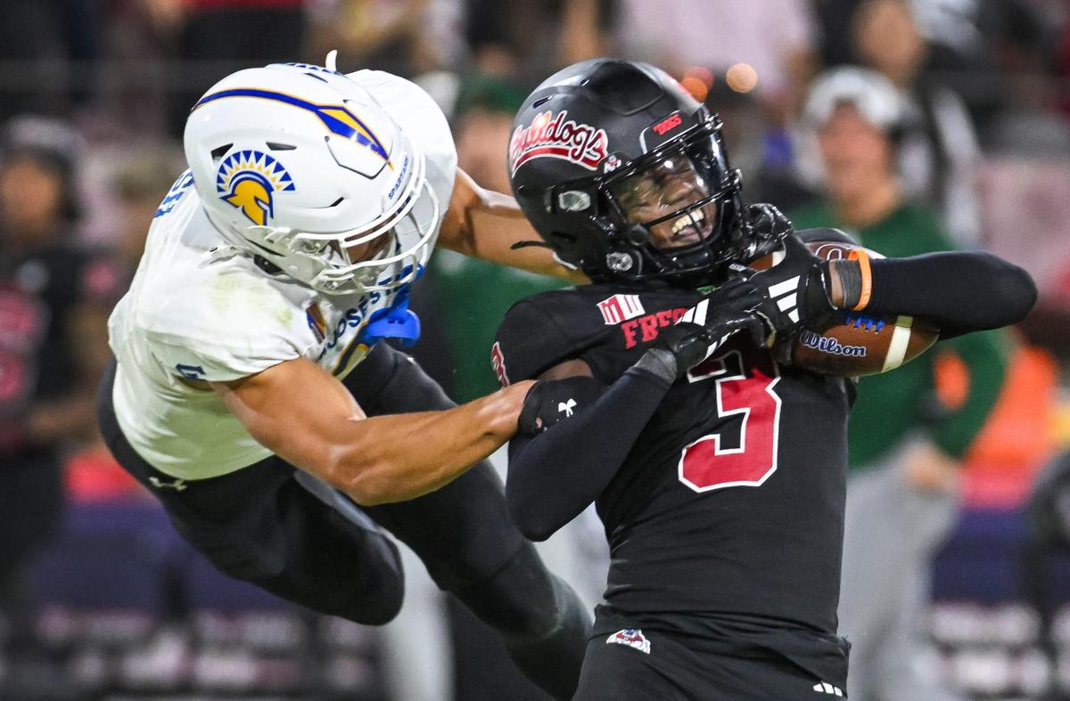 Fresno State’s Al’zillion Hamilton, right, gets pulled down from behind by San José State’s Nick Nash after intercepting the ball during their game at Valley Children’s Stadium in Fresno on Saturday, Oct. 26, 2024.